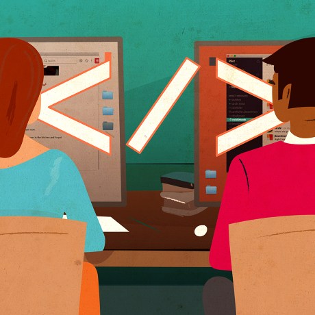 Two engineers sitting side by side working.