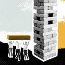 A metaphor for team building activities, this image features 3 people lifting up a life-size Jenga piece.