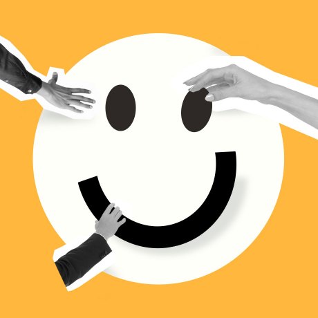 employee happiness hero hands putting a happy face together